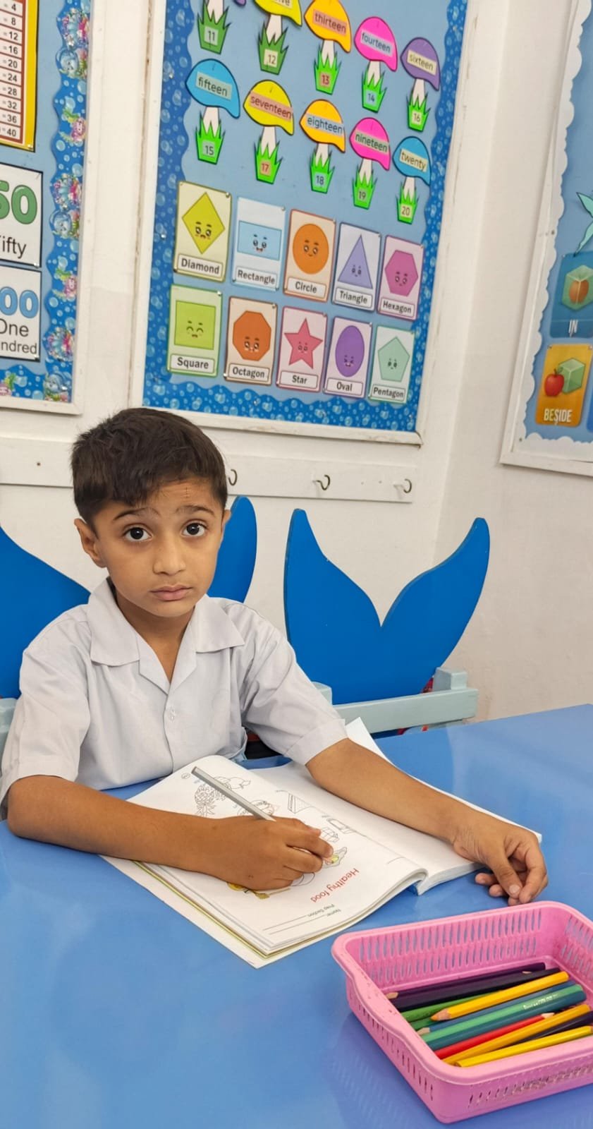 A Warsis student at his desk during a classroom activity