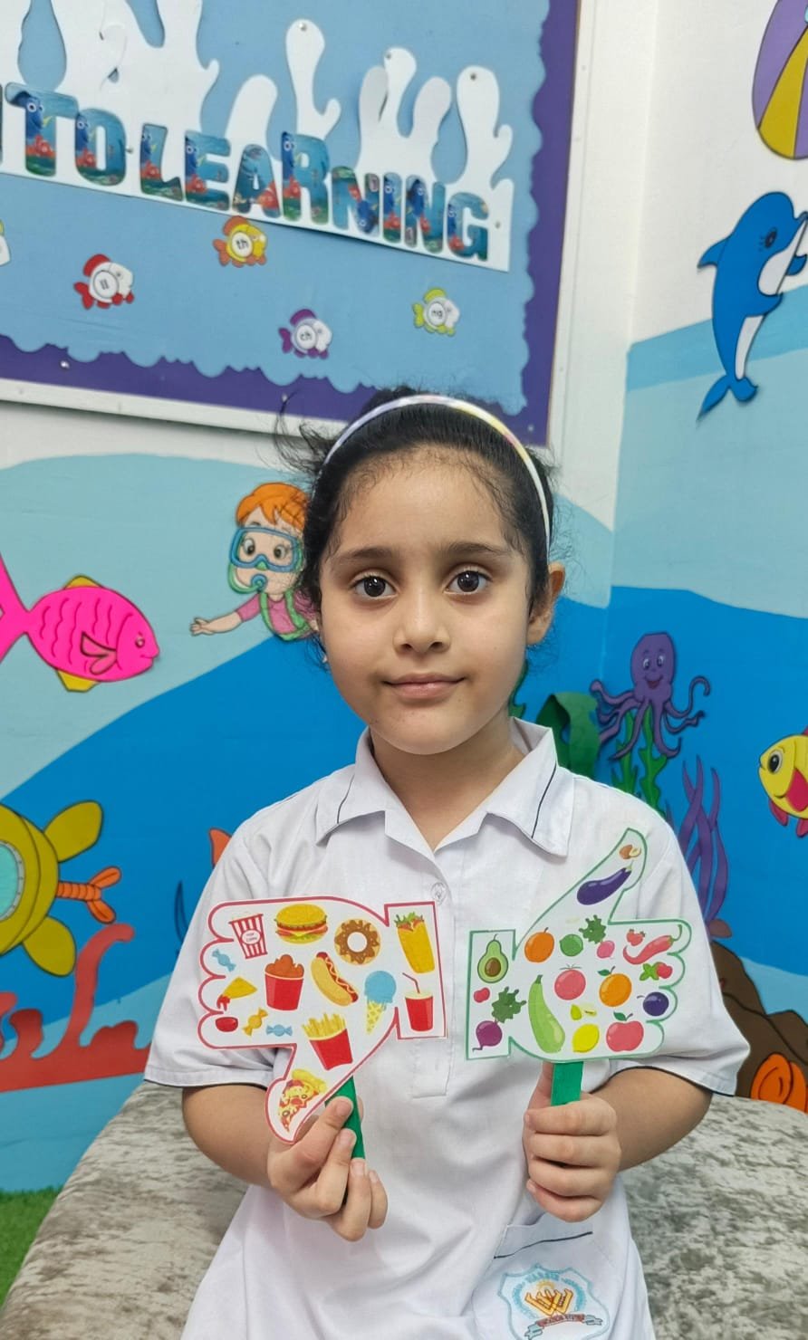 A Warsis student displaying her healthy-food sorting activity