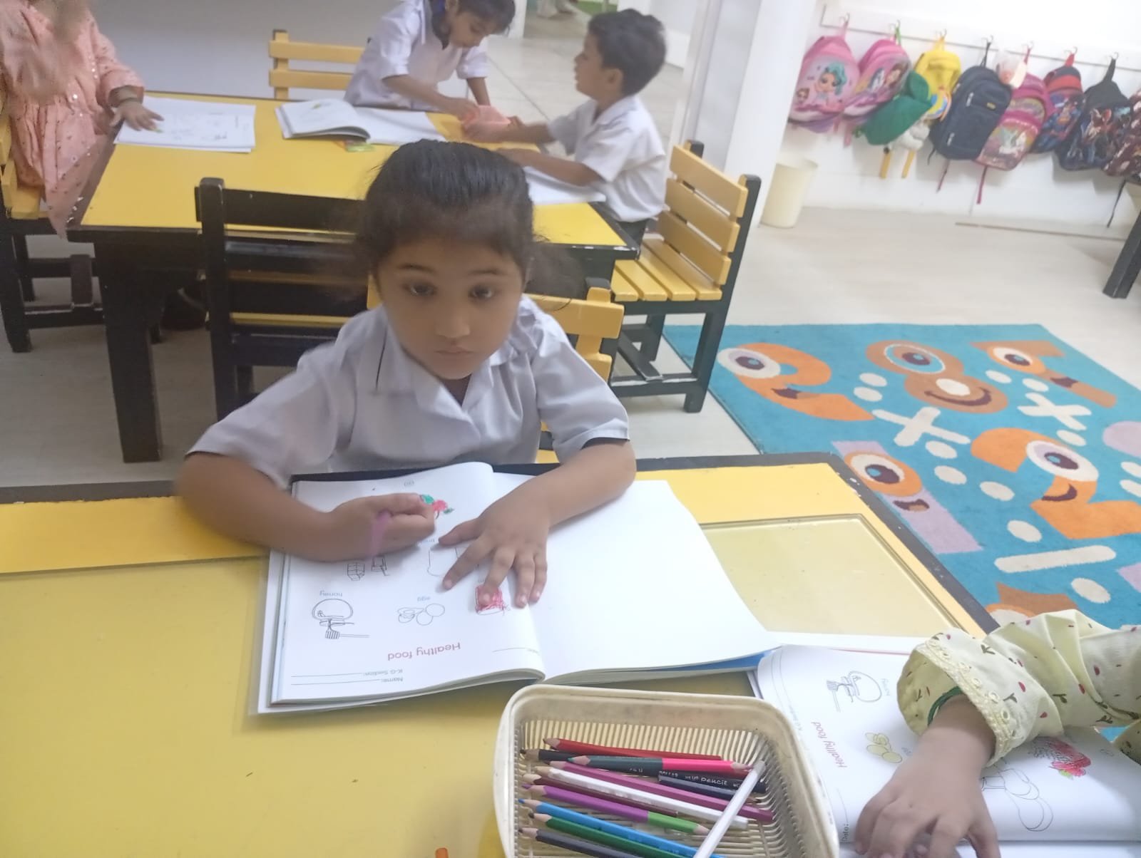 Warsis students working in a bright Montessori classroom
