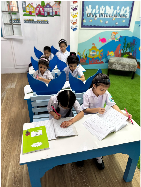 Montessori students practising handwriting at their classroom tables