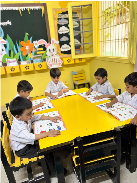 Young Warsis students working through picture books at a classroom table