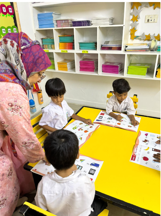 A Warsis directress guiding Montessori students through a reading exercise