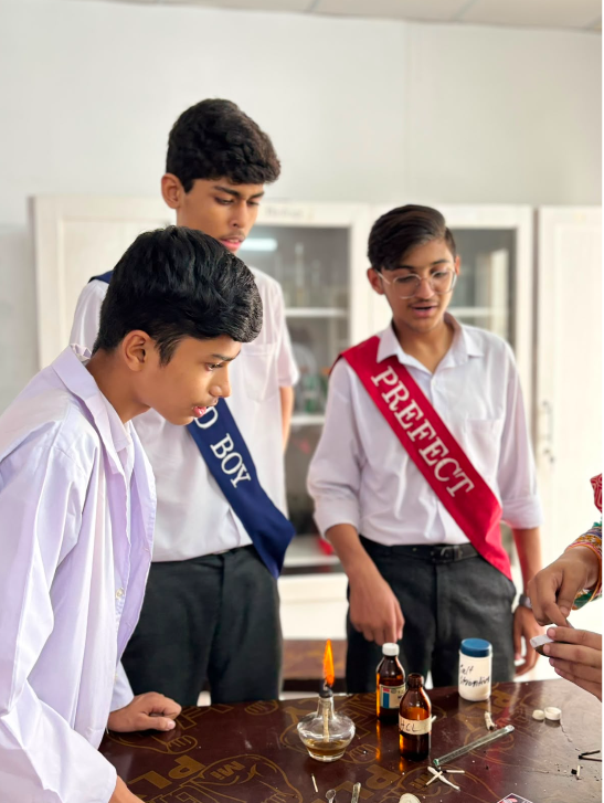 The head boy and a prefect assisting during a Warsis laboratory session