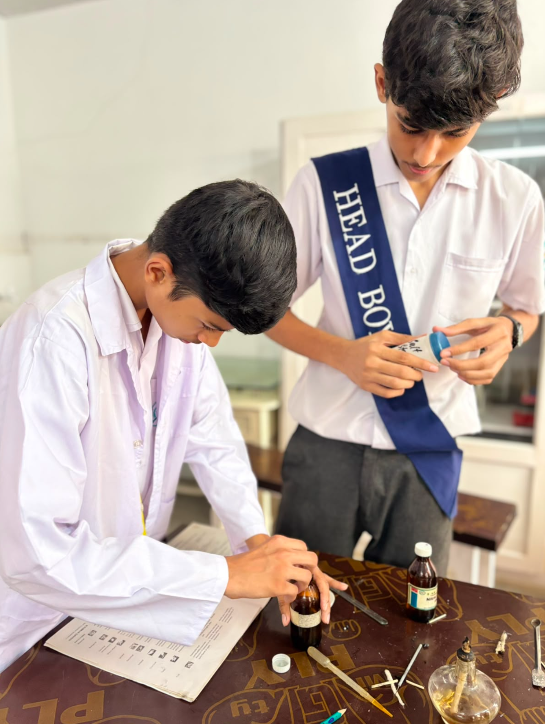 Warsis Secondary students preparing reagents during a chemistry practical