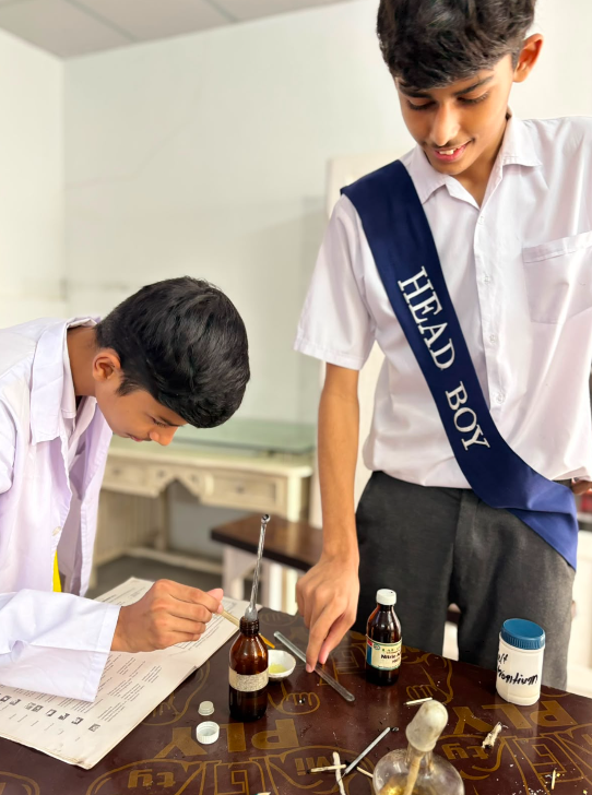 A Warsis Secondary student recording his laboratory observations